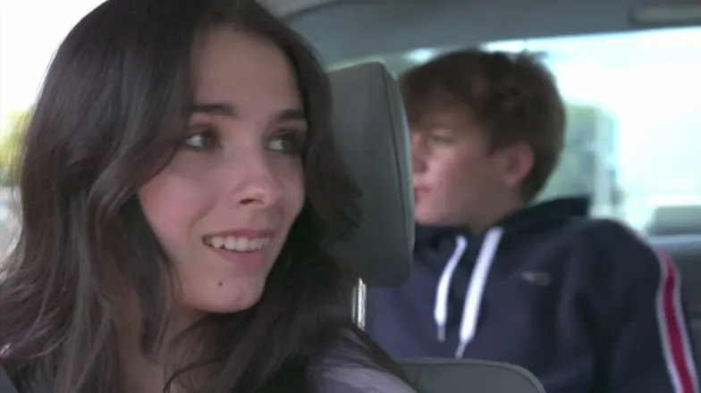 Elisabeth Fitzgerald in the back seat of a car, smiling