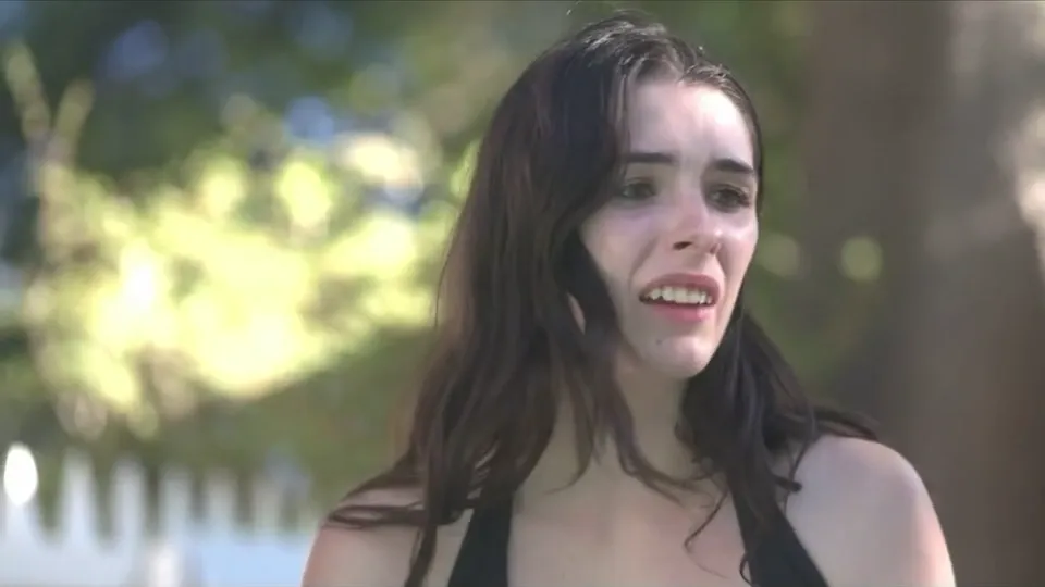 Elisabeth Fitzgerald by a swimming pool, wet hair, mid line